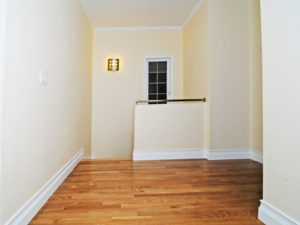 Second floor upper foyer showing stairs, window and light.